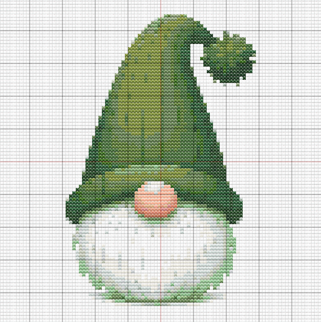 Free cross stitch pattern of a green gnome with tall curled hat, white beard, and peach nose, stitched in cozy winter colors.